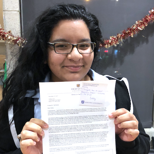 Student holding acceptance letter