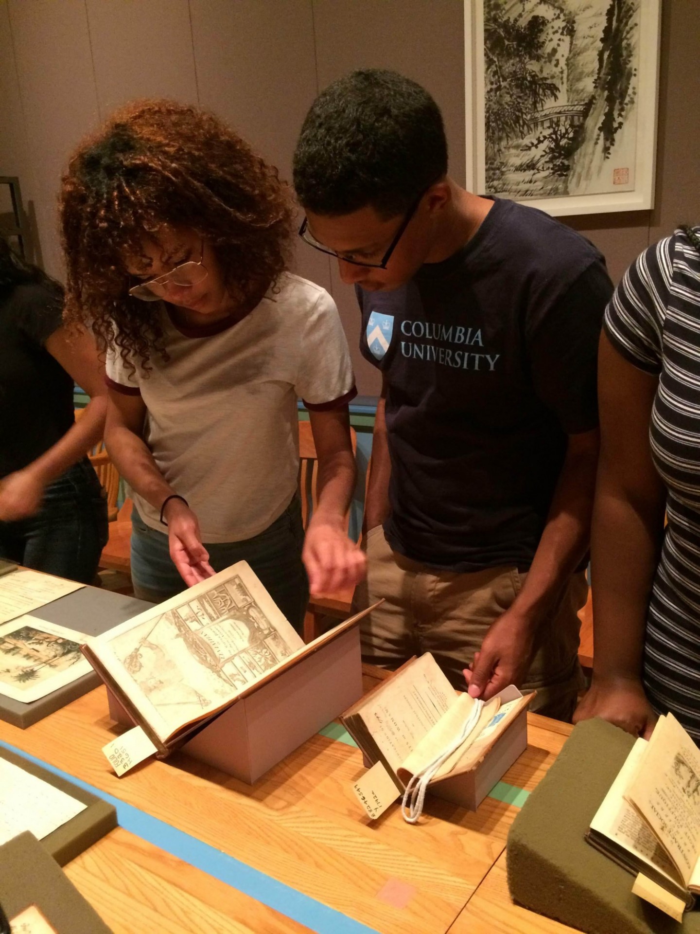 Jennifer (left) and another student looking at documents in Columbia's Rare Book and Manuscript Library