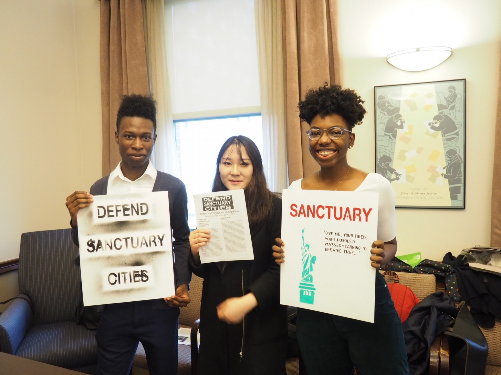 Chrisjen with his classmates holding up signs to defend sanctuary cities