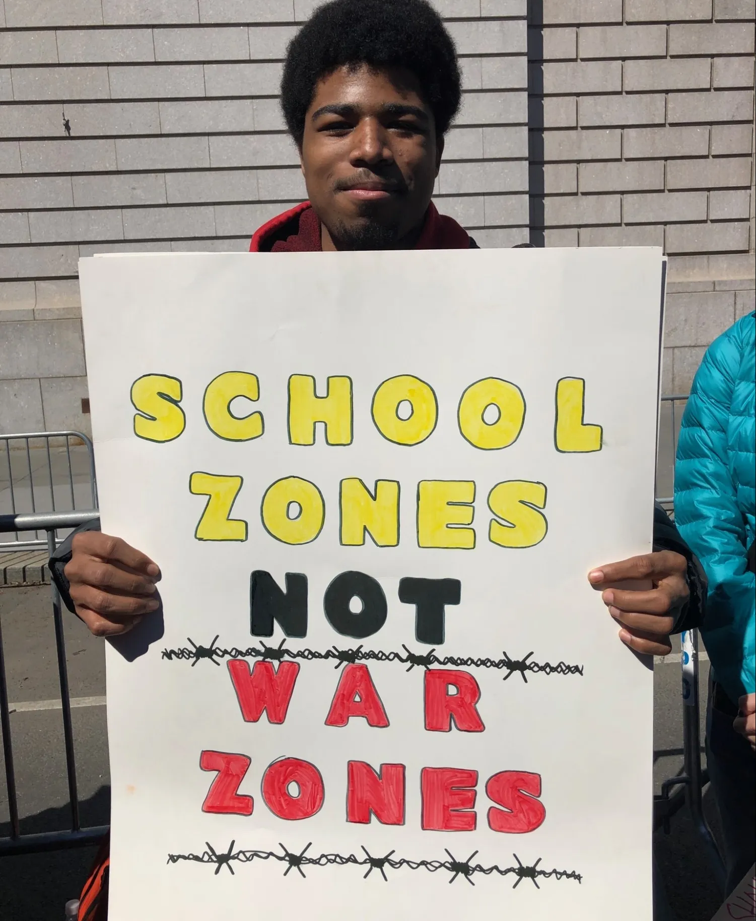 boy holding sign