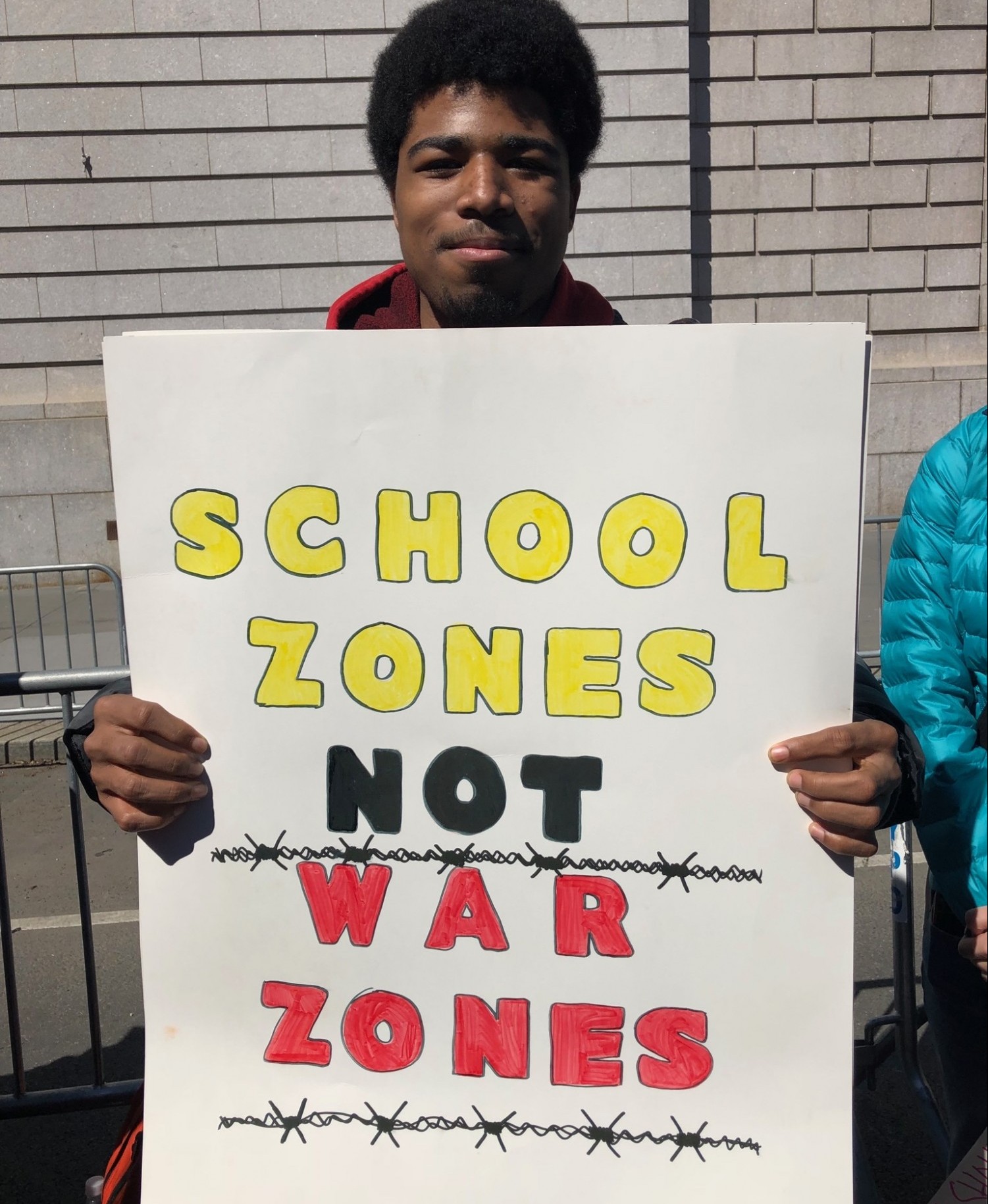 boy holding sign