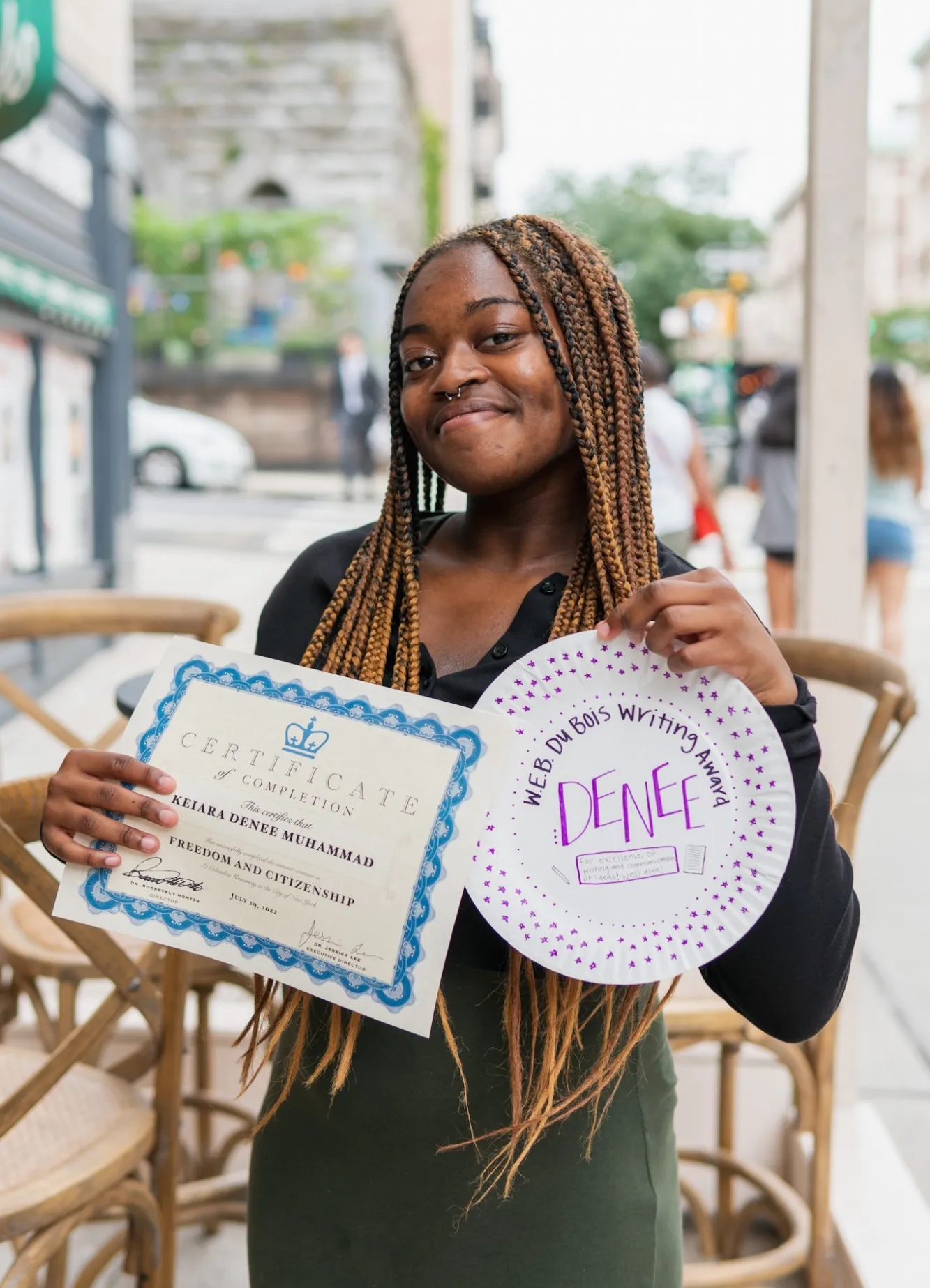 Student holding certificate 