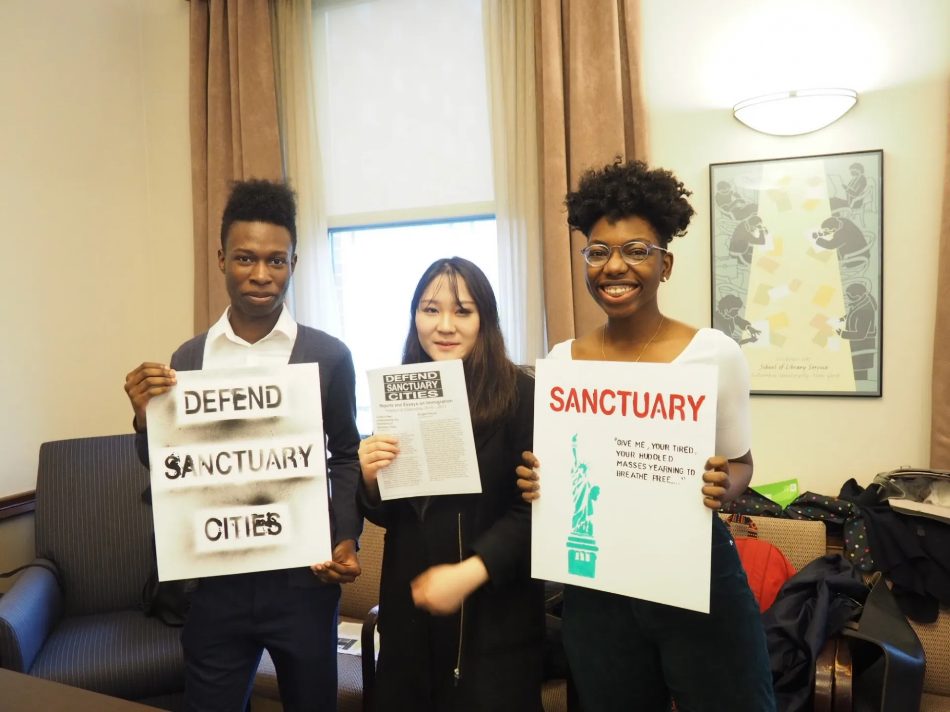 Chrisjen with his classmates holding up signs to defend sanctuary cities