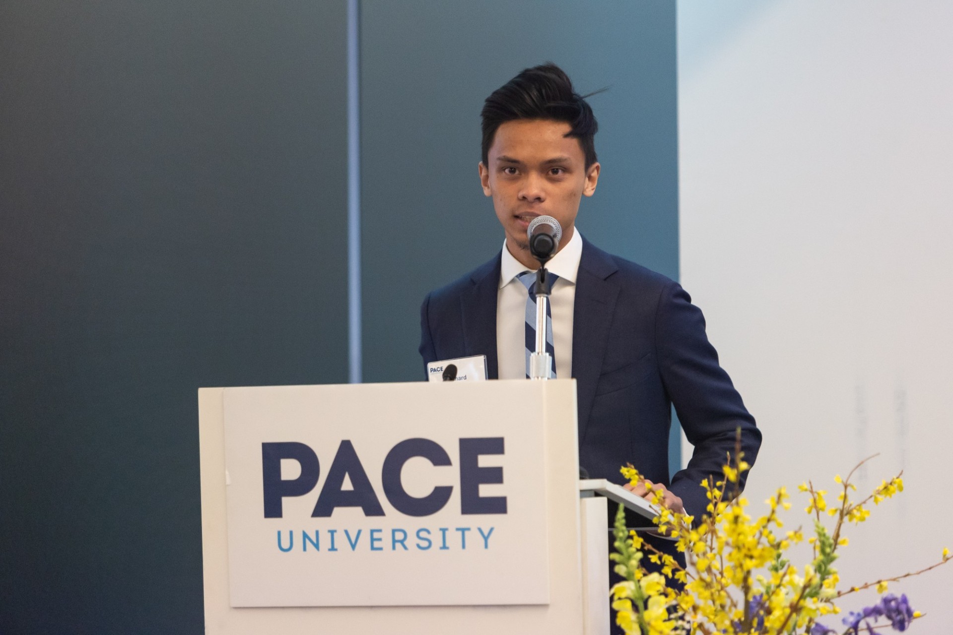 Richard DeDios speaking at podium