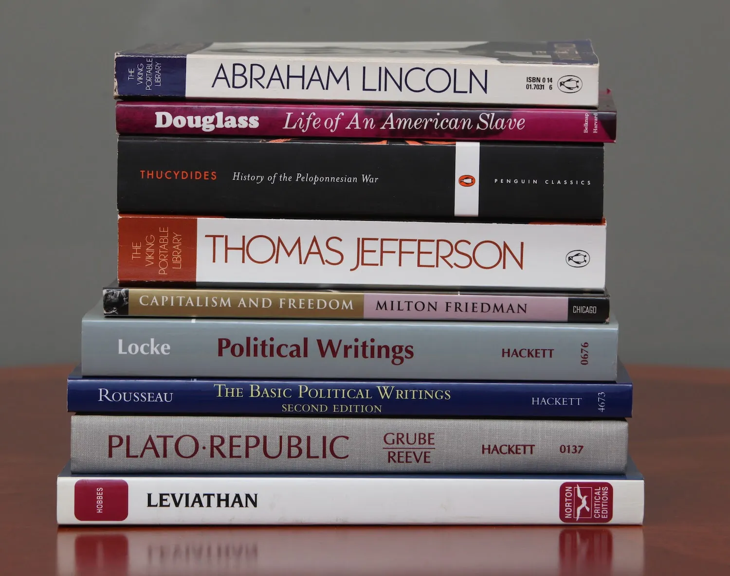 stack of books: lincoln, douglass, thucydides, jefferson, friedman, locke, rousseau, plato
